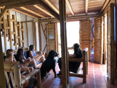 a group of women sitting in a room with a dog at Hotel La Montoya in Curití
