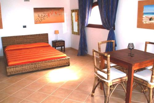 a bedroom with a bed and a table and a dining room at Oleandro Ocean Apartment in Santa Maria