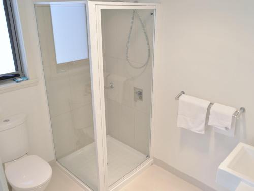 a shower with a glass door in a bathroom at 170 Hazards View - Unit 1 in Coles Bay