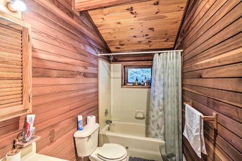 a bathroom with wooden walls and a toilet and a tub at Berkshires Cabin 2 Mi to Appalachian Trail! in Otis
