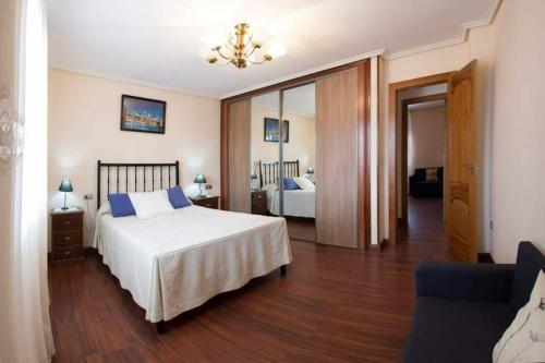 a hotel room with a bed and a living room at Villa Paula in Avilés