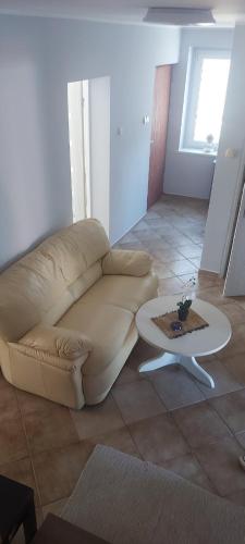 a living room with a couch and a coffee table at Ночлеги - HOSTEL in Tarnowo Podgórne