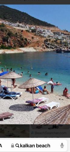 a group of people in the water at a beach at SONSUZ in Kalkan