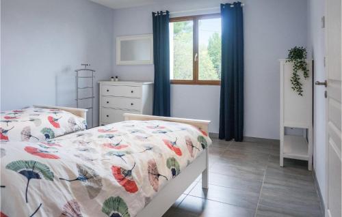 a bedroom with a bed and a window at 3 Bedroom Cozy Home In Caunes Minervois in Caunes-Minervois