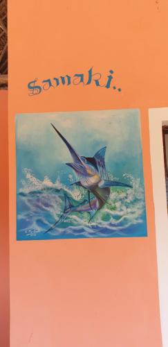 a book with a picture of a fish in the water at SAMAKI VILLAGE in Watamu