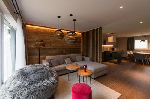 a living room with a couch and a table at Alm-Chalet Premium in Clausthal-Zellerfeld