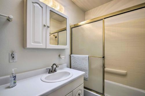 a white bathroom with a sink and a shower at Cortez Retreat with Office and Stunning Mtn Views in Cortez