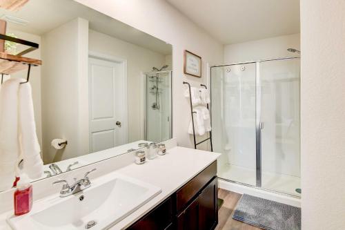 a white bathroom with a sink and a shower at Family-Friendly Bellmead Home about 6 Mi to Waco in Bellmead