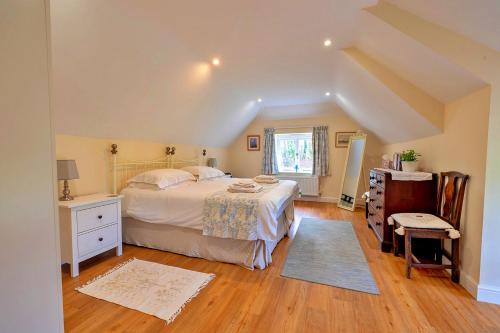 a bedroom with a large bed and a wooden floor at Finest Retreats - The Old Granary in Barton Stacey