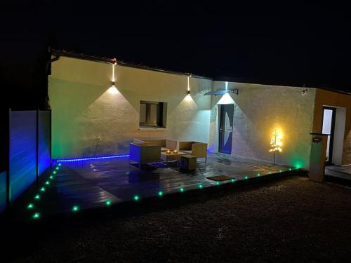 a house with a lit up patio at night at Makeda Love & Jacuzzi in Neuville-Saint-Amand