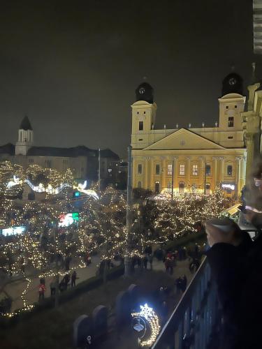 a large building with christmas lights in front of it at Visit Debrecen Apartman in Debrecen