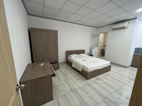 a room with a bed and a desk in it at Hello Hotel in Bùi Tiếng