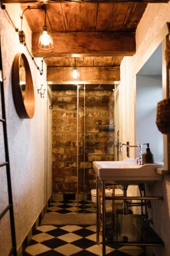 a bathroom with a sink and a glass shower at Potasznia 31 in Gądkowice