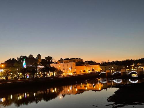 a city with a river and a bridge at night at Golden Club- Eyes on Sea in Cabanas de Tavira
