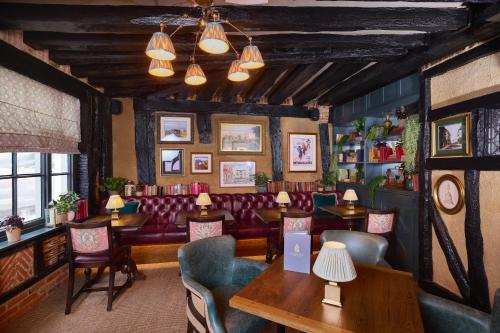 a restaurant with tables and chairs in a room at Salisbury Arms Hotel in Hertford
