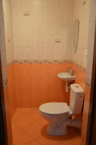 y baño con aseo y lavamanos. en ApartEłk - apartament w Ełku, en Ełk