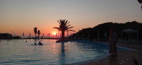 een groep mensen in een zwembad bij zonsondergang bij Casetta Delia in Palermo
