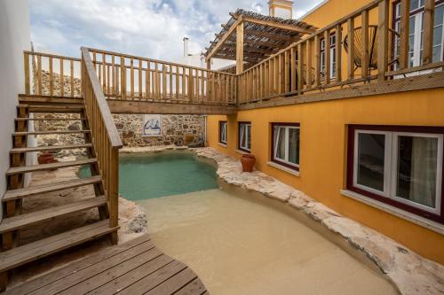a pool in the middle of a house with a staircase at Villa Galega in Silveira