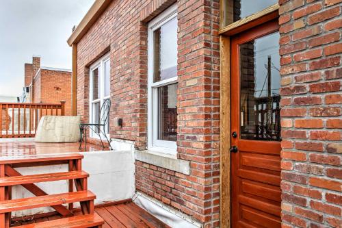 a brick house with a wooden door and a balcony at 1 Mi to UW Historic Laramie Apt in Laramie