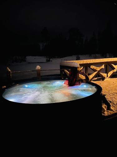 a small pool of water in front of a picnic table at Dzirnavas Pirtsmāja in Cesvaine