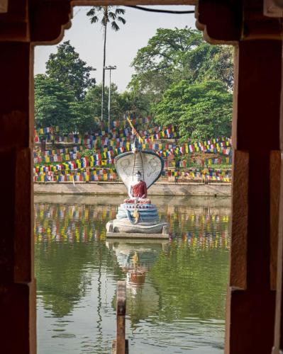a view of a fountain in a body of water at Nilam Guest House in Bodh Gaya