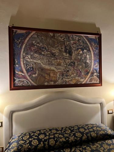 a tapestry hanging above a bed in a bedroom at Hotel Villa Liana in Florence