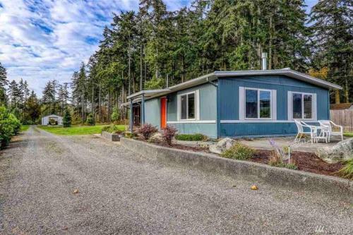 a blue tiny house on the side of a road at Beautiful Oceanview Retreat 2 Bedroom Home in Port Hadlock