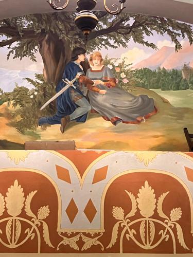 a painting of a man and woman on a wall at Hotel Villa Liana in Florence