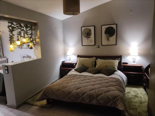 a bedroom with a large bed with two night stands at Wine Reflections Apartment near Nafplio in Néa Kíos