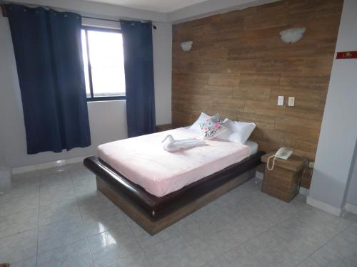 a small bedroom with a bed with a window at ART CASCO The Hotel in Panama City