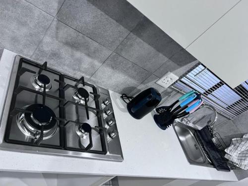 a stove top with pots and pans on a kitchen counter at Beevap Guesthouse in Pretoria