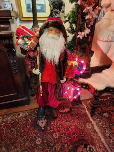 a santa claus figurine holding a bag of presents at House of 1833 Bed and Breakfast in Mystic