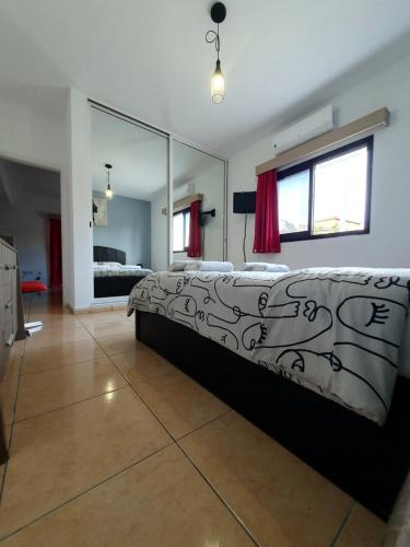 a bedroom with a bed and a large mirror at Valentina Apartments in Paphos