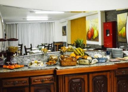 a kitchen with a bunch of fruit on a counter at Hotel Monet in Erechim