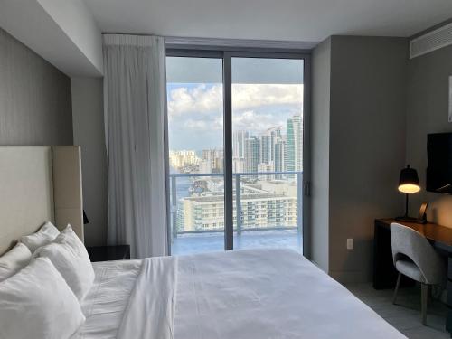 a bedroom with a bed and a large window at Hyde Beach House Lux Apartment in Hollywood