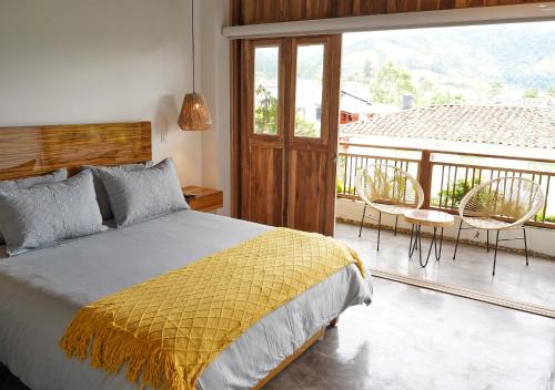 a bedroom with a bed and a balcony with chairs at Panorama Salento by DOT Boutique in Salento