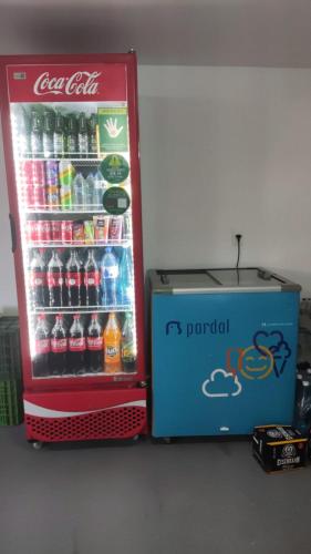 a cocacola refrigerator next to a box of soda at CUMBUCO - Eco Paradise - AP 112 in Caucaia