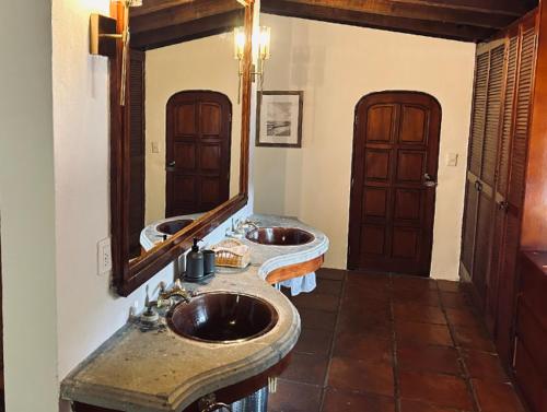 La salle de bains est pourvue de 2 lavabos et d'un miroir. dans l'établissement Villa Tatala hotel boutique, à Tepoztlán