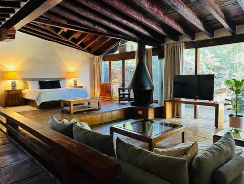 a large living room with a bed and a couch at Villa Tatala hotel boutique in Tepoztlán