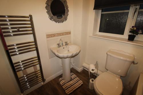 a bathroom with a toilet and a sink at Stirling House Sheffield by Smart Corporate Stays in Sheffield
