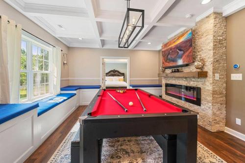 a room with a pool table and a fireplace at Cozy 2b 2b Spa 2 Steam Saunas Home Theater Gym in Davidson