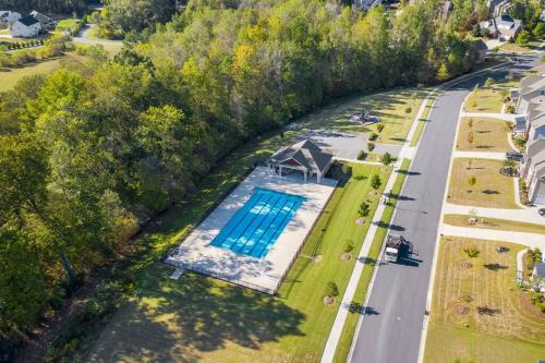 an overhead view of a swimming pool next to a road at Cozy 2b 2b Spa 2 Steam Saunas Home Theater Gym in Davidson
