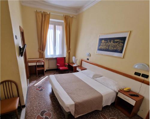 a hotel room with a bed and a desk at Albergo Boccadasse in Genoa