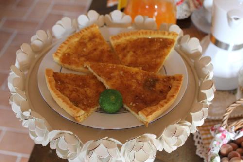 a plate with slices of pizza and a lime at B&B Il Poggetto in Serra SantʼAbbondio