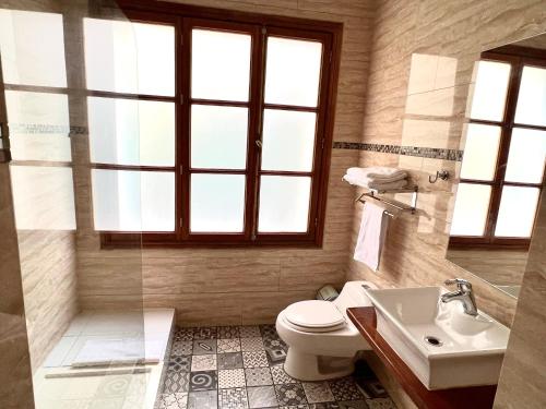 a bathroom with a toilet and a sink at Hotel Boutique Casa Noble in Santiago