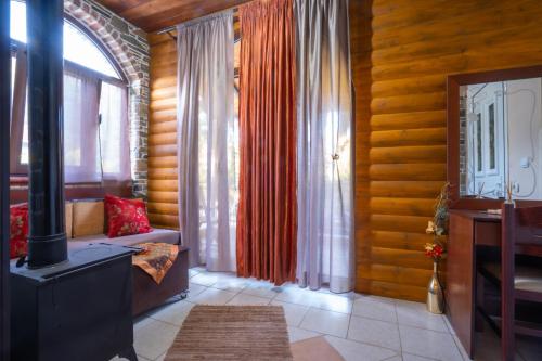a living room with wood paneling and a room with a television at Ξενώνας Μαίανδρος in Aridaia