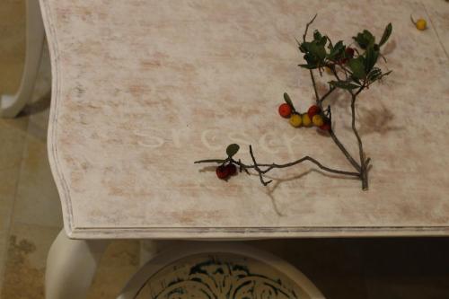 a table with flowers and fruit on top of it at Apartmani Pelješac Sova in Sreser