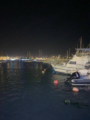 a group of boats docked in a marina at night at Lovely Apartment In Mindelo City Center in Mindelo