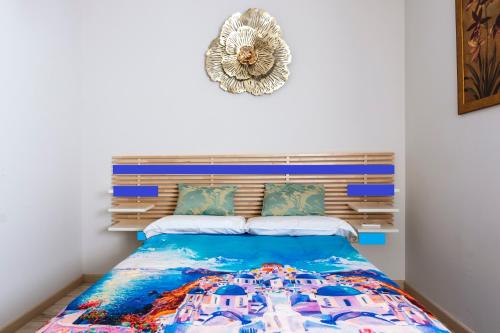 a bedroom with a bed with a blue bedspread at Icon Center in Almería