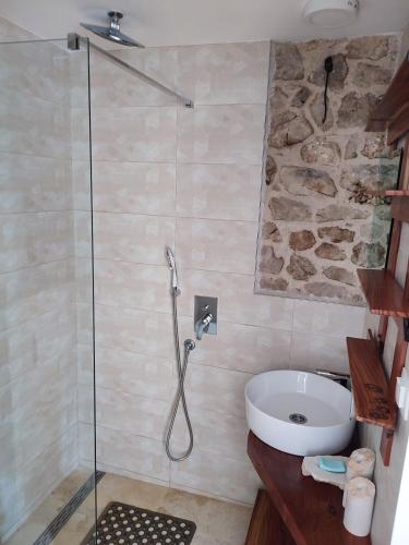 a bathroom with a shower and a sink at Apartmani Pelješac Sova in Sreser